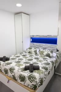 a bedroom with a large bed with a blue headboard at Wonderful stay in Tenerife Royal Gardens Resort! in Playa de las Americas +22 photos