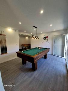 a living room with a pool table in it at Chalet familial 6 chambres 250m2 in Le Dévoluy