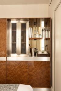 a kitchen with stainless steel cabinets and a counter at Hotel Palais Bourbon in Paris