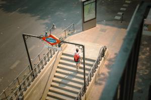 a person walking up some stairs with a sign at Atocha Rooms in Madrid +6 photos