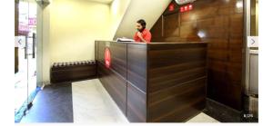 a man sitting at a counter in a restaurant at Hotel O Alpine in Chandīgarh +10 photos