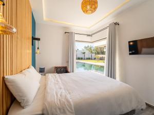 a bedroom with a bed and a large window at DAR PITXI - Personnel inclu in Essaouira +28 photos