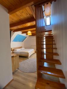 a staircase in a room with a bed and a bedroom at Gegest Hotel in Theth