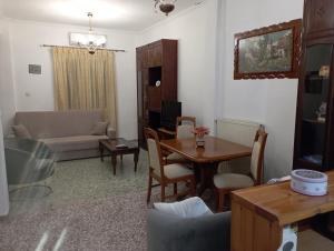 a living room with a table and a couch at Sweet Home Lefkas in Lefkada Town
