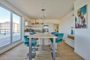 a kitchen and dining room with a table and chairs at Stunning 2BR Flat with Terrace and private parking in Strasbourg