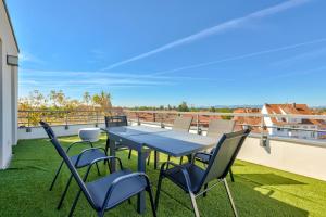 a table and chairs on the roof of a house at Stunning 2BR Flat with Terrace and private parking in Strasbourg