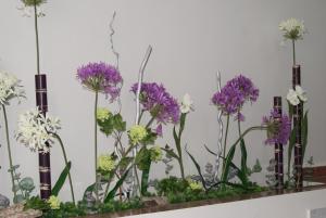 a bunch of purple and white flowers in glass vases at Hotel Doña Luisa in San Luis de Sabinillas