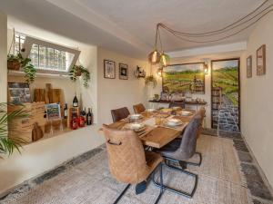 a dining room with a table and chairs at La Casa Della Seta in Tremezzo