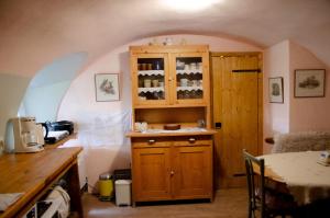 a kitchen with a wooden cabinet with wine bottles at Srub v županu in Prachatice