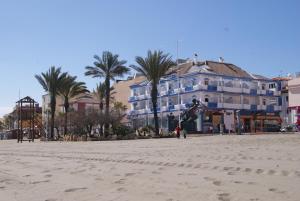 a person jumping in the air on the beach at Hotel Doña Luisa in San Luis de Sabinillas +37 photos