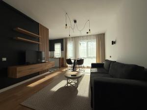 a living room with a couch and a table at BCB Aparts Wood Nest in Floreşti