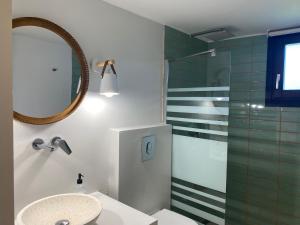 a bathroom with a sink and a shower at Paralies Resort in Skiathos Town +28 photos