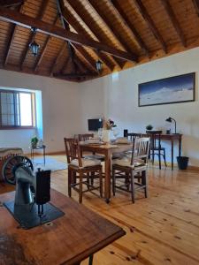 a living room with a wooden table and chairs at Casa con alma canaria in Los Realejos
