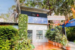 a building with plants in front of it at Super Collection O Ulife in Mumbai
