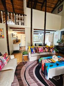 a living room with a bed and a couch at Bergvliet Cottages - Salvado and Esparanza in Clarens
