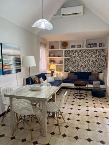 a living room with a table and chairs and a couch at TC Bungalow Melocotones 15 in Maspalomas