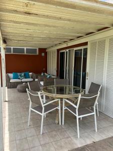 a patio with a glass table and chairs at TC Bungalow Melocotones 15 in Maspalomas