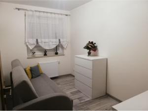 a living room with a couch and a white dresser at Apartament Rodzinny, 3 pokoje, 65m2, DARMOWY PARKING, place zabaw, siłownia in Wrocław