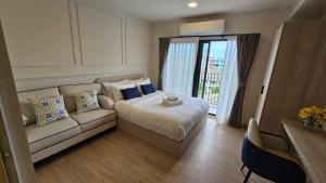 a hotel room with a bed and a couch at Cabanas Huahin by PTA in Hua Hin
