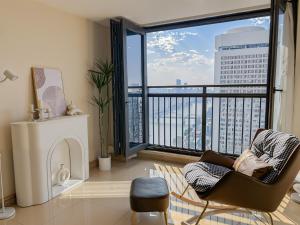 a living room with a chair and a large window at Qingfeng B&B in Guangzhou
