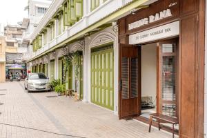 a row of buildings on a street with a bench at Nueng Rana 232 Corner view 1BR Duplex 3beds / 2B in Samphanthawong
