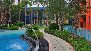 a resort with a swimming pool and a building at Cabanas Huahin by PTA in Hua Hin