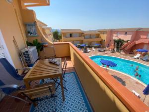 a balcony with a view of a swimming pool at Il Mamuthones in Badesi
