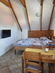 a room with a bed and a table and a dining room at Sklep u Veselých in Mutěnice