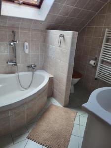 a bathroom with a tub and a toilet and a sink at Sklep u Veselých in Mutěnice +37 photos