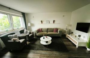 a living room with a couch and a table at Ferienwohnung Gute Zeit in Sundern