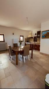 a kitchen and dining room with a table and chairs at Dimora Donna Carmela in Capaci +11 photos