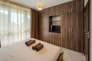 a bedroom with a bed with two brown towels on it at The Boulevard Luxury Apartment 3 in Sofia