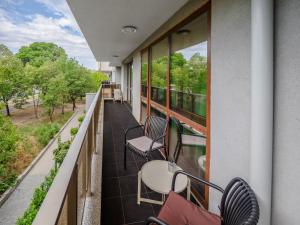 a balcony with chairs and tables and windows at The Boulevard Luxury Apartment 3 in Sofia