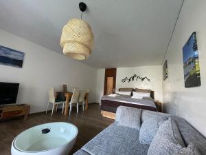 sala de estar con cama y bañera en Modern eingerichtete Ferienwohnung Traumtagerl ruhig, zentral, ideal für Familien & Paare, en Bad Tölz