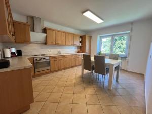 a kitchen with a table and chairs and a table and a table and a kitchen at Ferienwohnung Bliesgau in Blieskastel