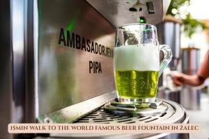 a glass of beer sitting on top of a toaster at Bed & Breakfast Dvorec in Petrovče