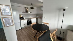 a kitchen with a table and chairs in a room at Casas de Valtravieso El Jardín in El Pozo de los Frailes