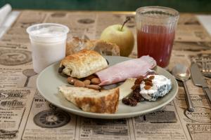 a plate of breakfast food on a table at Hôtel de Biencourt in Azay-le-Rideau