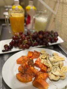 a plate of food with fruit on a table at Hotel Guaíba in Guaíba
