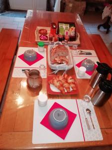 a wooden table with food on top of it at LA LONGÈRE - Chambre Aubrac 