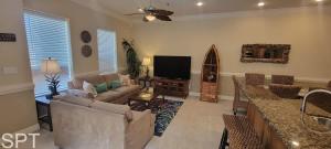 a living room with a couch and a tv at Island Time #4 in South Padre Island