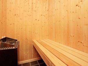 a corner of a room with a wooden wall at 4 star holiday home in Ålbæk in Bunken +24 photos