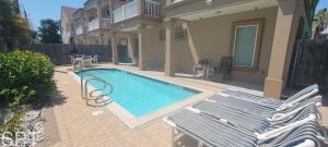 a swimming pool in front of a house at Island Time #4 in South Padre Island