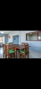 Un comedor con mesa y sillas de madera. en La casa de stella, en Rosario de la Frontera
