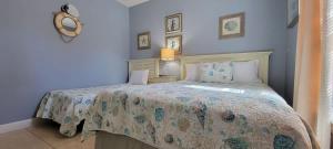 a bedroom with a bed with a blue wall at Mar y Sol II #1 in South Padre Island +70 photos