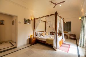 a bedroom with a bed with a canopy at Hotel Raj Bagh Palace in Jaipur +56 photos