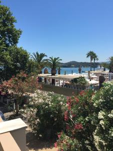 a view of a resort with a bench and flowers at Malibu Summer Studios in Dassia