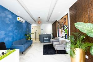 an office lobby with blue walls and blue furniture at 233 Boulevard by QUAO REALTY in Accra