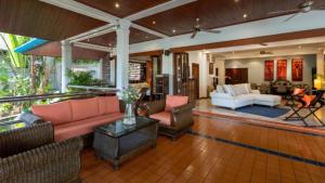 a large living room with couches and chairs at The Nai Harn Collective in Rawai Beach +33 photos
