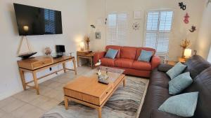 a living room with a couch and a table at Beach & Palms condo in South Padre Island